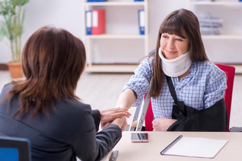 A woman discussing a claim with an Anaheim personal injury attorney after an accident.