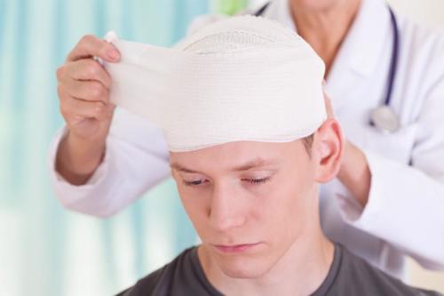A man having his head treated for an injury after a car accident.