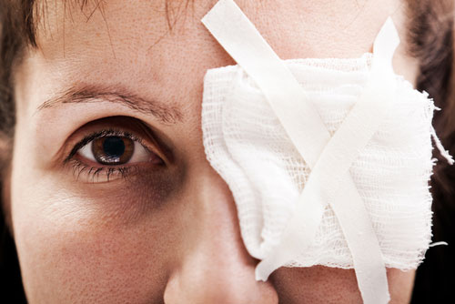Close up of woman with bandage over one eye