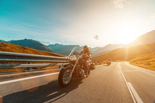 Man riding motorcycle on highway concept of Irvine motorcycle accident lawyer