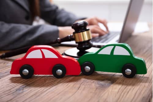 Lancaster car accident lawyer with model cars and gavel