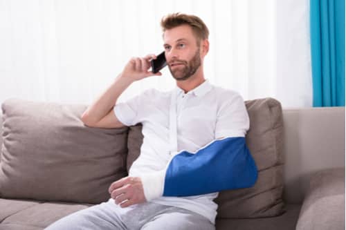 Young man with broken arm calling Lancaster personal injury lawyer