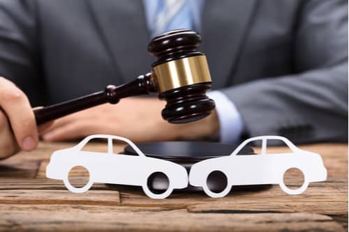 Palmdale car accident lawyer hits judge gavel near paper cars
