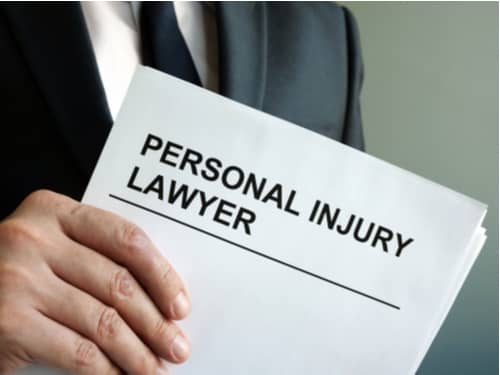 Palmdale personal injury lawyer holding document