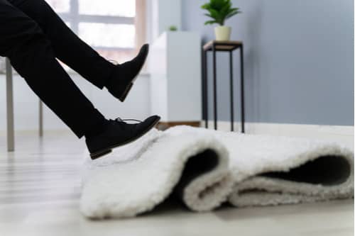 Man tripping on carpet Victorville slip and fall lawyer concept