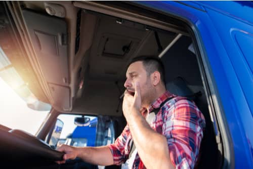 Truck driver yawning, accident liability concept