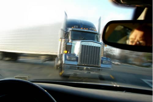 Large truck about to hit car, Victorville truck accident lawyer concept