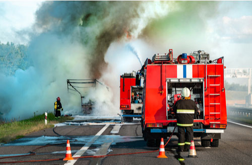 Irvine burn injury attorney concept firetruck extinguishes a burning car
