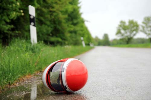 Motorcycle helmet on road, motorcycle accident concept