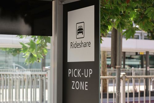 Image is of a sign for Rideshare pick up zone, concept of Fullerton Uber accident lawyer
