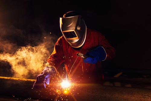 Image is of a worker welding metal concept of Moreno Valley burn injury lawyer