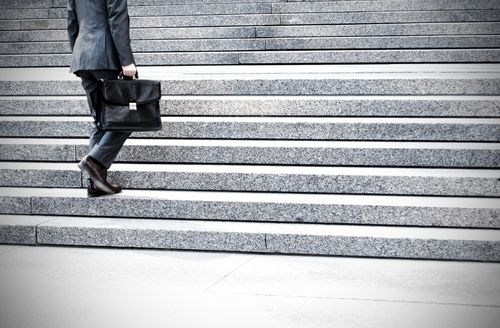Moreno Valley slip and fall injury lawyer walking up the steps of a courthouse 
