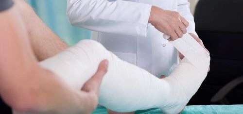 a doctor is bandaging a patient's leg