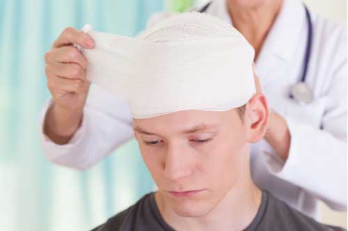 a doctor is bandaging a patient's head