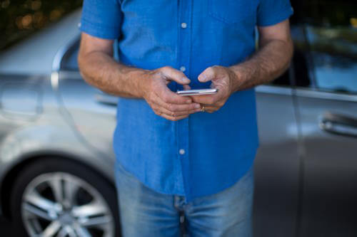 A man is holding a phone in his hands