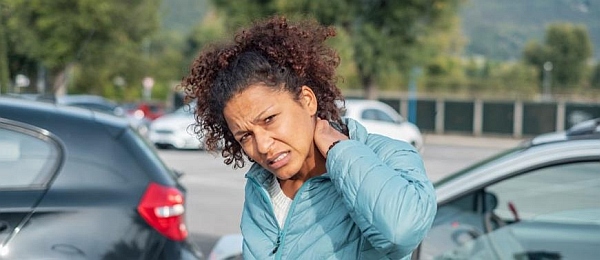 Photo of a woman holding her neck after the accident