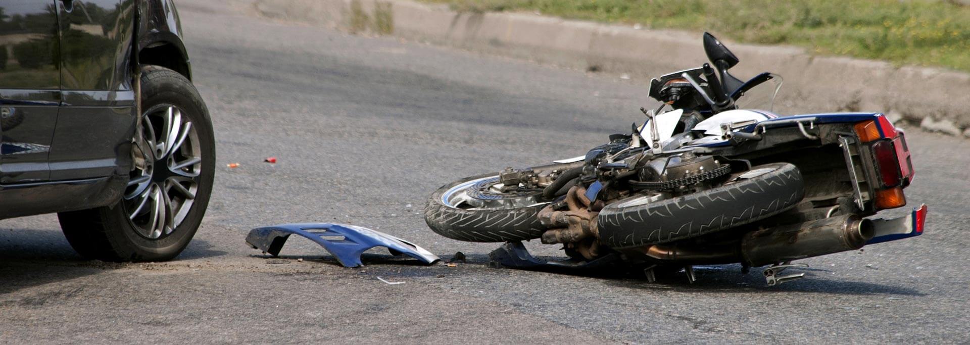 Photo of a motorcycle and a car after the accident