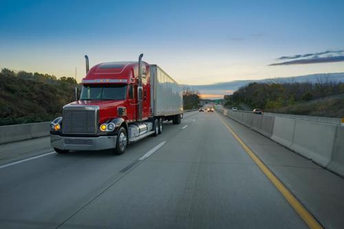 A truck driving down a highway.