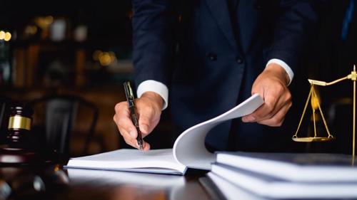 Photo of a judge making a note in a notebook