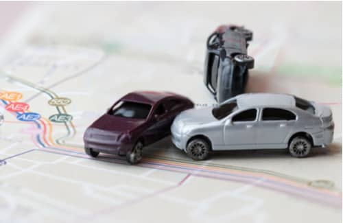 Model cars crashed on map, Lancaster car accident lawyer concept