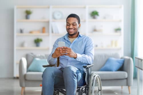 Young black man in wheelchair calling Victorville spinal cord injury lawyer