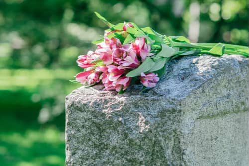 Pink flowers on grave, Victorville wrongful death lawyer concept