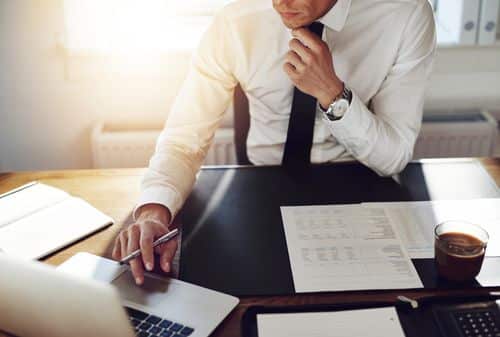 Image of a Fullerton car accident lawyer looking over a case while sitting at his desk.