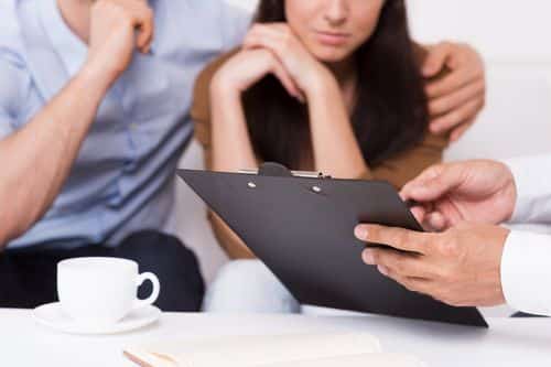 Image is of a couple looking at their case with their Fullerton catastrophic injury lawyer