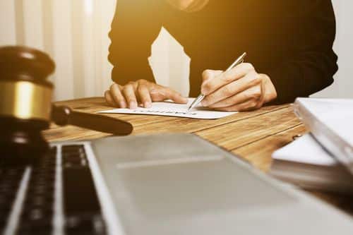 Irvine motorcycle accident lawyer working on a client's case at his desk