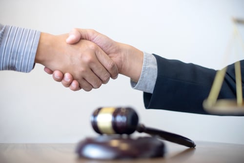 This is an image of a man shaking hands with his Twentynine Palms personal injury lawyer.