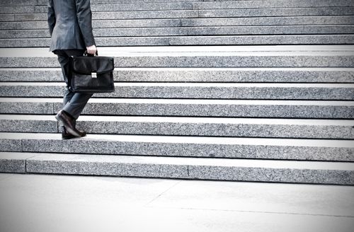 Moreno Valley slip and fall injury lawyer walking up the steps of a courthouse