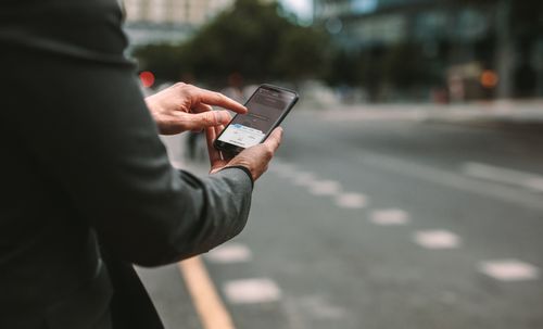 Man holding a phone using a rideshare app concept of Moreno Valley Uber accident lawyer