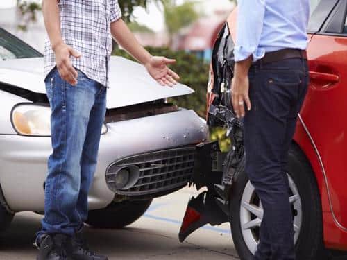 Two drivers in Santa Ana exchanging information after a car accident.