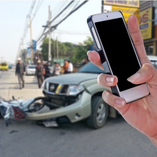 This is an image of a person about to call an Indian Wells car accident lawyer following a car accident